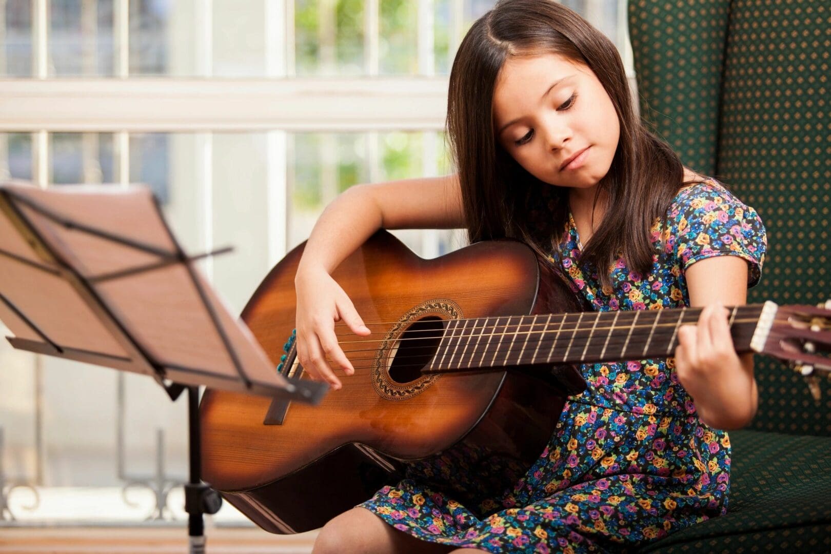 A girl is playing an acoustic guitar