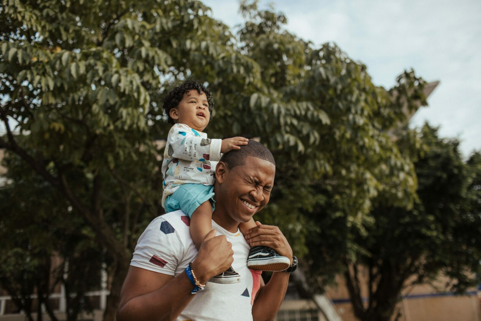 A man holding his son on top of him.