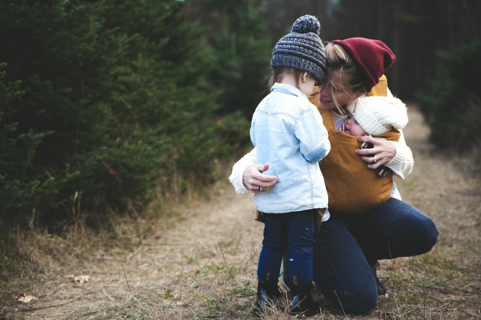 A woman and child looking at something on the ground.